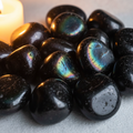 Rainbow obsidian tumbled stones cluster hero shot with iridescent rainbow sheen