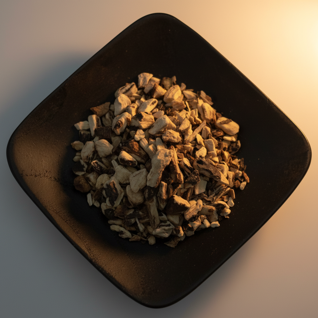 Comfrey root cut and sifted on black ceramic plate hero shot