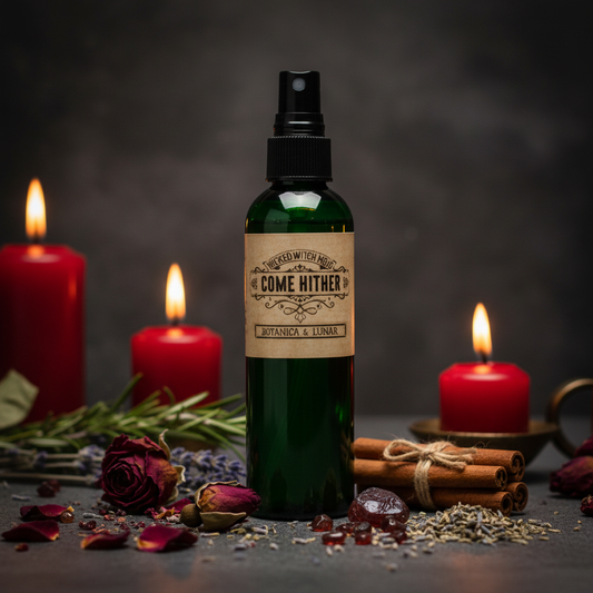 Wicked Witch Mojo Come Hither green spray bottle with red roses, garnet chips and cinnamon props