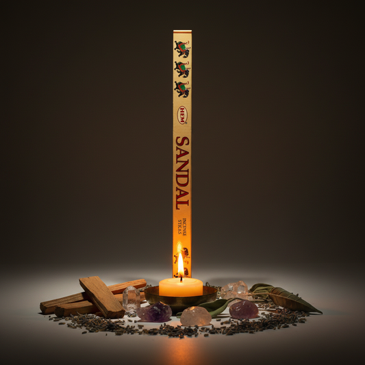 HEM Sandal incense hex box standing upright with HEM at top, sandalwood chips, crystals and candlelight