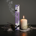 Dark Angel incense packaging standing upright with lavender, white feathers and candle props
