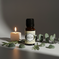Blessed Herbal Healing Oil hero shot - amber bottle with flat cap, crystals and candlelight