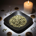Dried lemon verbena on black ceramic plate with candle and crystals