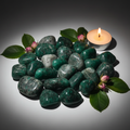 Cluster of emerald tumbled stones with pink rose buds and green leaves props