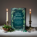 The Green Witch's Grimoire book standing upright with herbs and candlelight