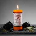 Wicked Witch Mojo Bitch Be Gone orange pillar candle standing upright with witchy protection props