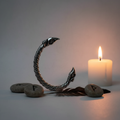 Small Odin's Raven Pewter Viking Bracelet hero shot with rune stones and candlelight