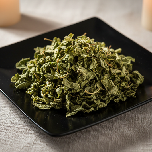 Dried green raspberry leaf on black ceramic plate hero shot