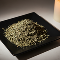 Dried wormwood herb on black ceramic plate hero shot