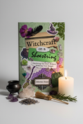 Witchcraft on a Shoestring book hero shot with cauldron, crystals and candlelight
