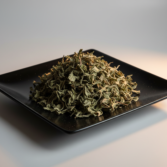 Dried peppermint leaf on black ceramic plate hero shot