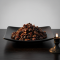 Dried seedless rose hips on black ceramic plate with bright white background