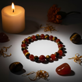 Carnelian and Tiger Eye bracelet hero shot with stones and candlelight