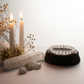 Selenite 8mm beaded stretch bracelet with raw selenite wand and white flowers on light grey background