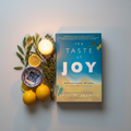 The Taste of Joy by Emily A. Francis - hero shot with olive branch and Mediterranean props on light grey background